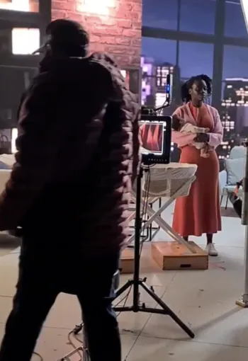 Film set with people working in the background.