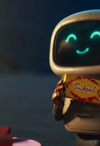 Robot smiling whilst holding Suchard's.